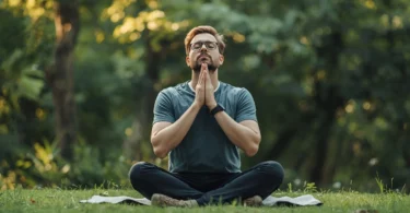 Person sitting quietly in nature practicing deep breathing to recover from emotional flooding and feeling emotionally overloaded.