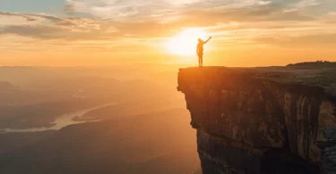 Person standing at edge of cliff symbolizing risk-taking, embracing uncertainty, and personal growth
